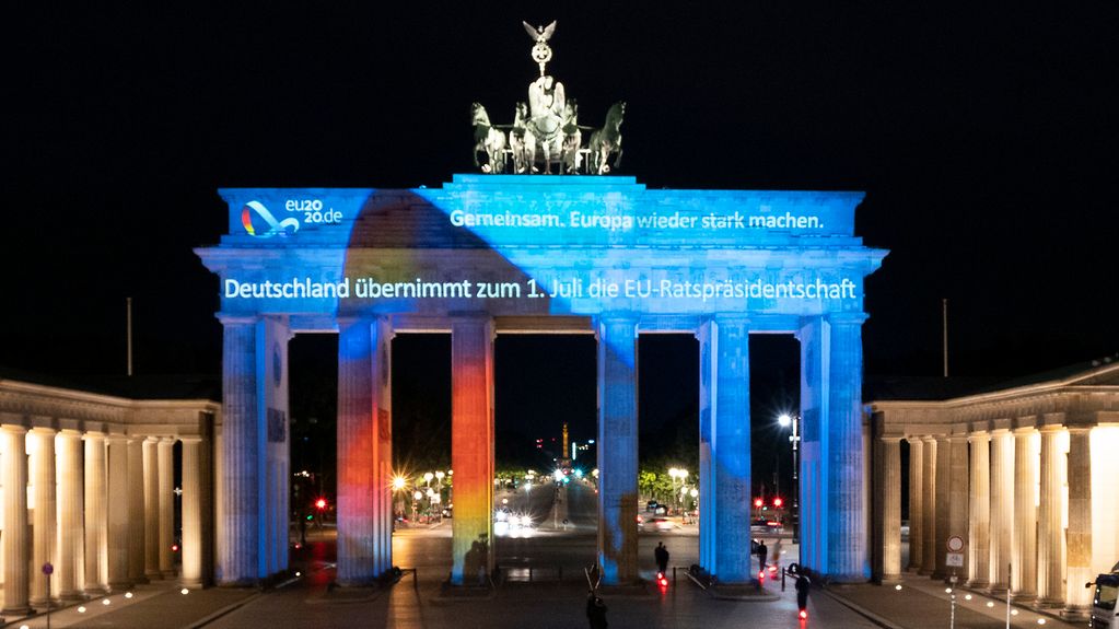 The Brandenburg Gate in Berlin is illuminated with the motto of Germany's Presidency of the Council of the European Union - a "Together for Europe's recovery".