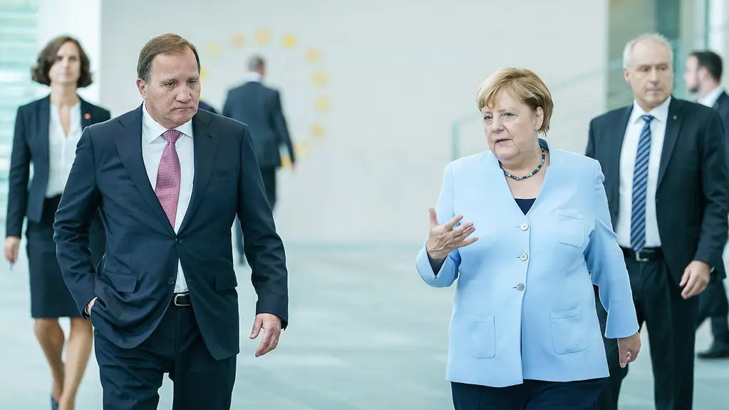 Chancellor Angela Merkel in conversation with Stefan Löfven, Sweden's Prime Minister