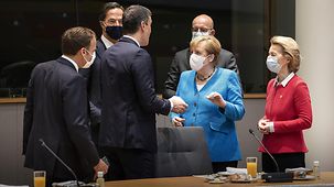 Chancellor Angela Merkel speaks with other leaders during the European Council meeting in Brussels.