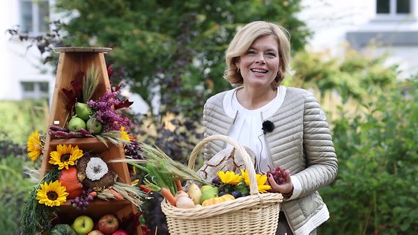 Bundeslandwirtschaftsministerin Kllöckner trägt einen Gemüsekorb