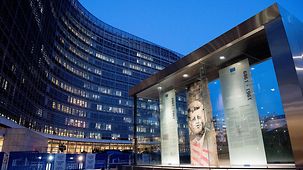A section of the Berlin Wall bearing the image of John F. Kennedy in front of the Berlaymont building in Brussels
