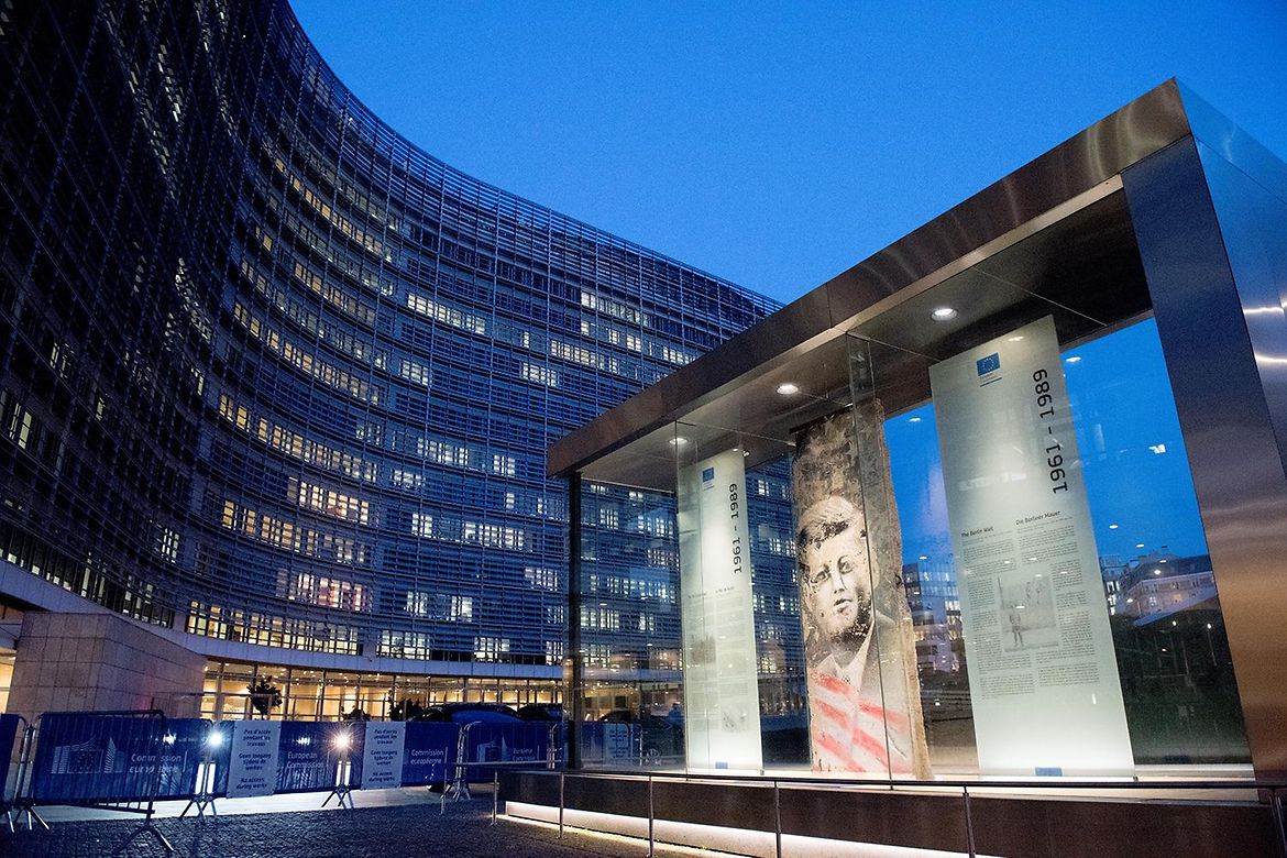 A section of the Berlin Wall bearing the image of John F. Kennedy in front of the Berlaymont building in Brussels