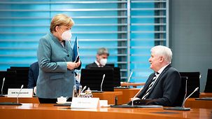 Chancellor Angela Merkel in conversation with Horst Seehofer, Federal Minister of the Interior, Building and Community before the Cabinet meeting