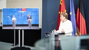Chancellor at the press conference; European Commission President and the President of the European Council were linked by video
