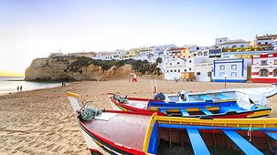 The beach in Carvoeiro with brightly painted boats