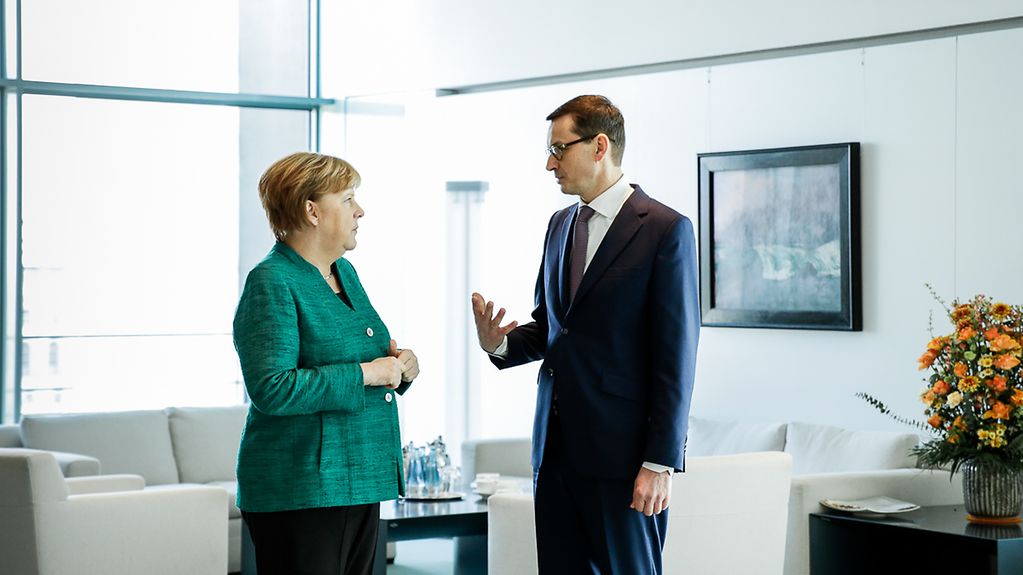 Chancellor Angela Merkel in conversation with Prime Minister Mateusz Morawiecki