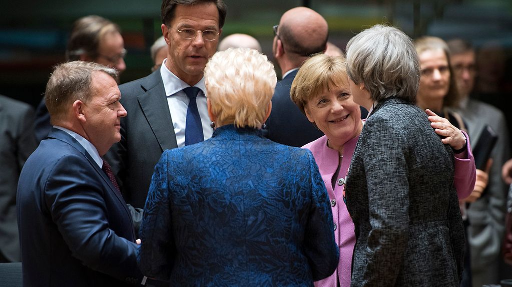 Chancellor Angela Merkel in conversation before a European Council session