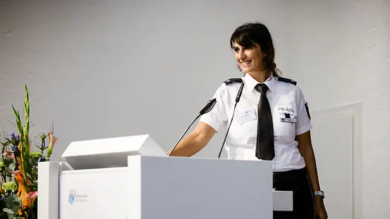 Polizistin am Rednerpult spricht