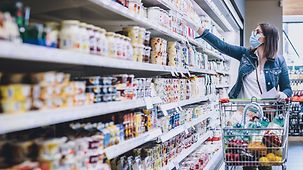 Foto zeigt eine Frau beim Einkaufen im Supermarkt.