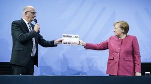 At the meeting with the Heads of Government of the Eastern Länder, Dietmar Woidke, Brandenburg's Minister President, presents Chancellor Angela Merkel with a book.