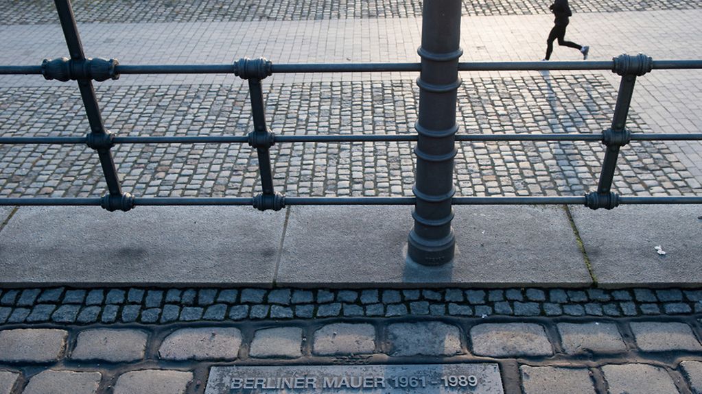 Ehemaliger Verlauf der Berliner Mauer gekennzeichnet durch Mauersteine im Boden.