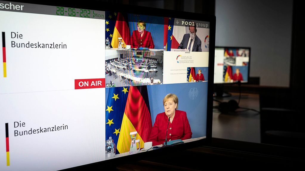 Sur des écrans, la chancelière fédérale Angela Merkel participant à l’Assemblée parlementaire franco-allemande