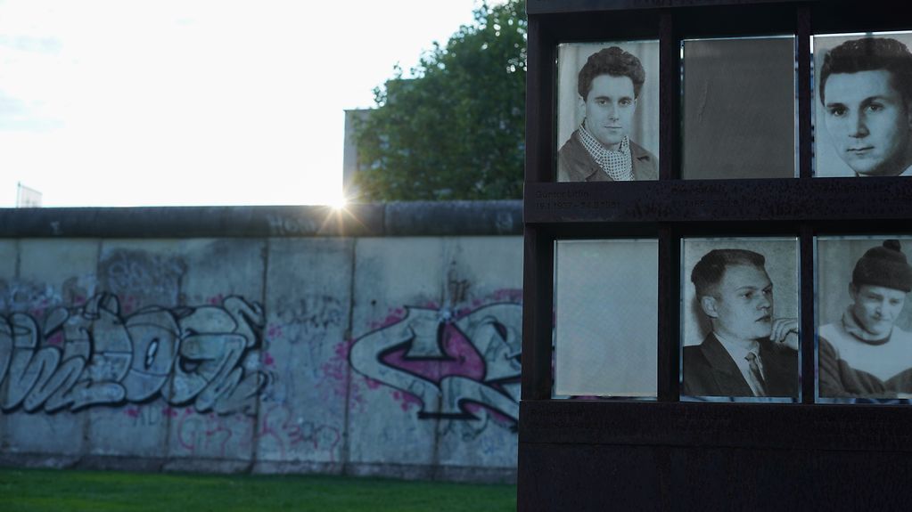 Part of the Berlin Wall and pictures of victims