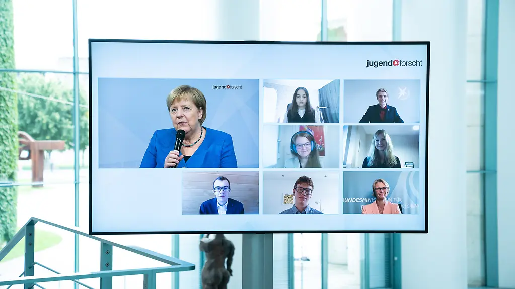 Ein Monitor zeigt die Teilnehmerinnen und Teilnehmer bei der Preisverleihung von "Jugend forscht"