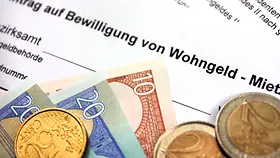 Antrag auf Wohngeld mit Münzen und Euro-Scheinen