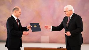 Federal President Frank-Walter Steinmeier presents Olaf Scholz with his certificate of appointment as Federal Chancellor.