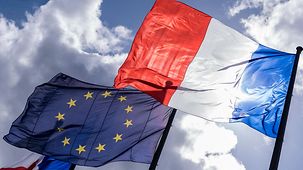 French and EU flag photographed against the light