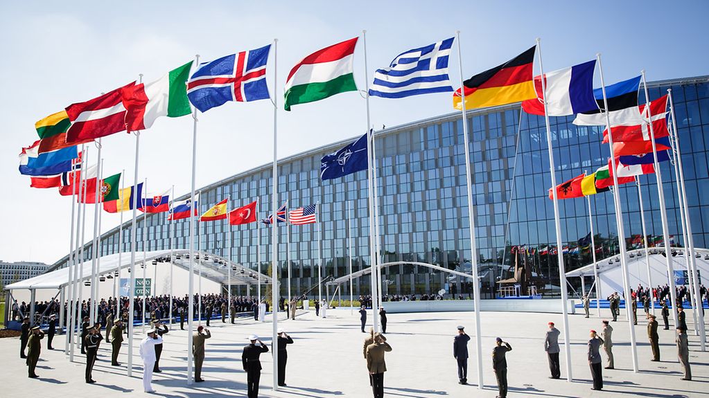 Flags of NATO member states flying in front of the NATO headquarters in Brussels.