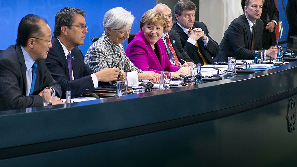 Angela Merkel and the heads of leading economic and financial organisations