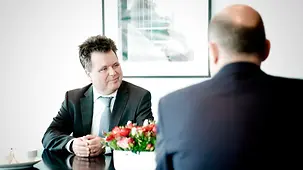 Federal Chancellor Olaf Scholz conversing with Jürgen Dusel, Federal Government Commissioner for Matters relating to Persons with Disabilities.