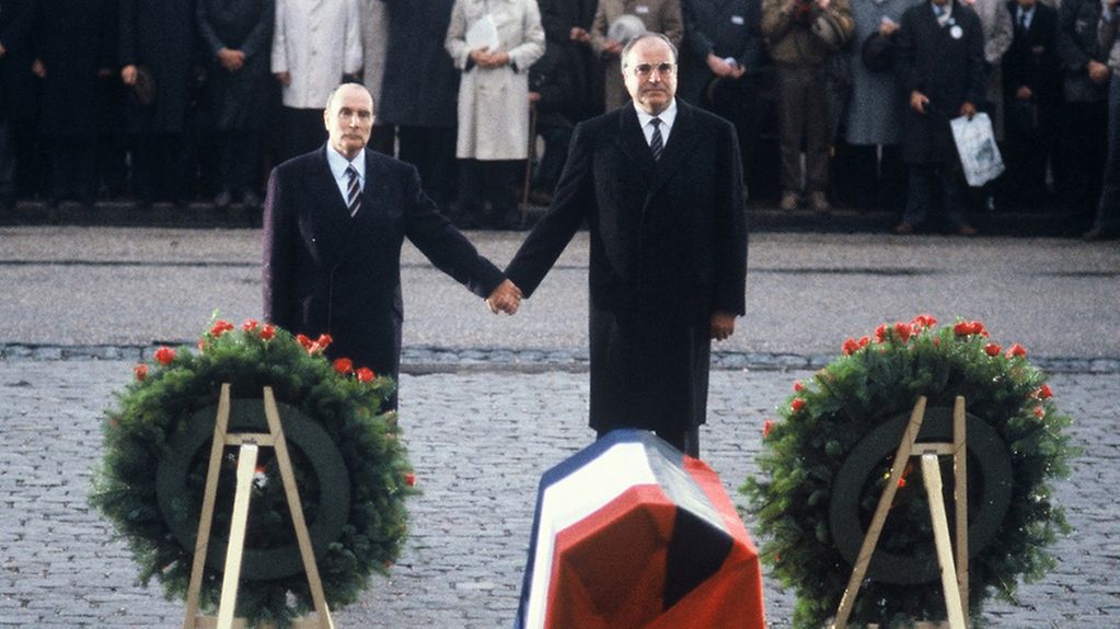 German Chancellor Helmut Kohl (right) and French President Francois Mitterrand at the French National Cemetery in Douaumont, holding hands while honouring soldiers from both countries who died in the two World Wars.