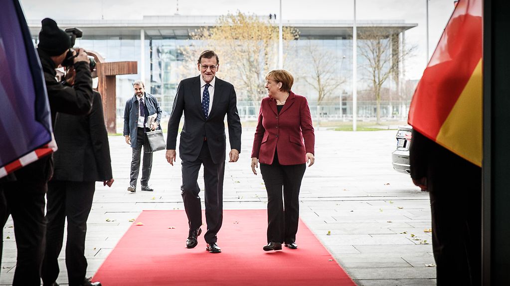 Chancellor Angela Merkel greets Spnaish Prime Minister Mariano Rajoy at the Federal Chancellery.