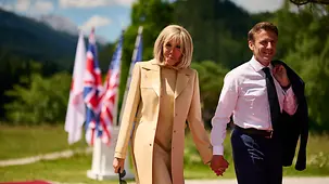 French President Emmanuel Macron and his wife Brigitte make their way to the official welcome to the G7 summit at Schloss Elmau.