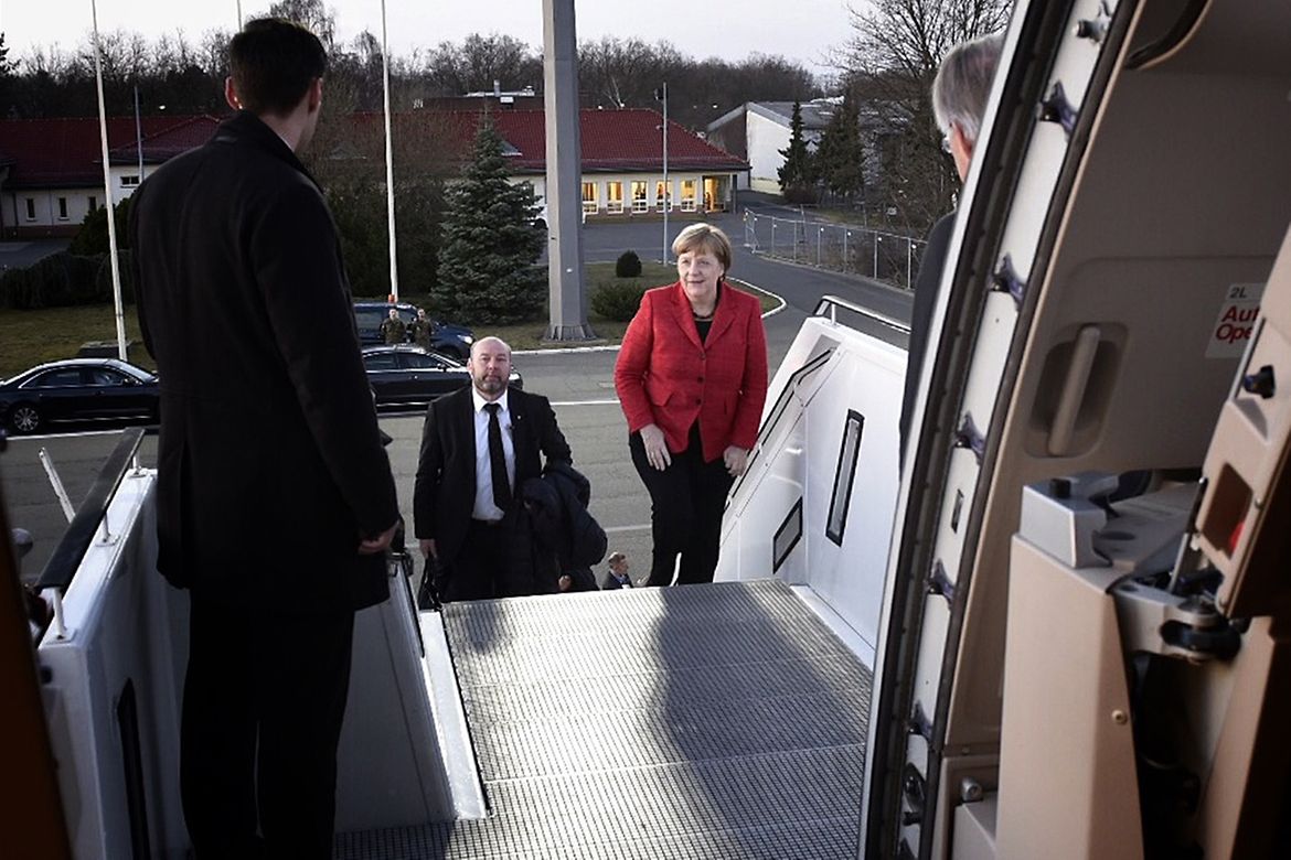 Chancellor Angela Merkel enters the aircraft.