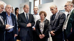 Federal Chancellor Olaf Scholz with Israeli Prime Minister Jair Lapid in the House of the Wannsee Conference with survivors of the Holocaust.