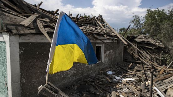 The photo shows a destroyed building in Ukraine