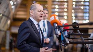 Federal Chancellor Olaf Scholz giving a statement on his arrival at the EU Council.