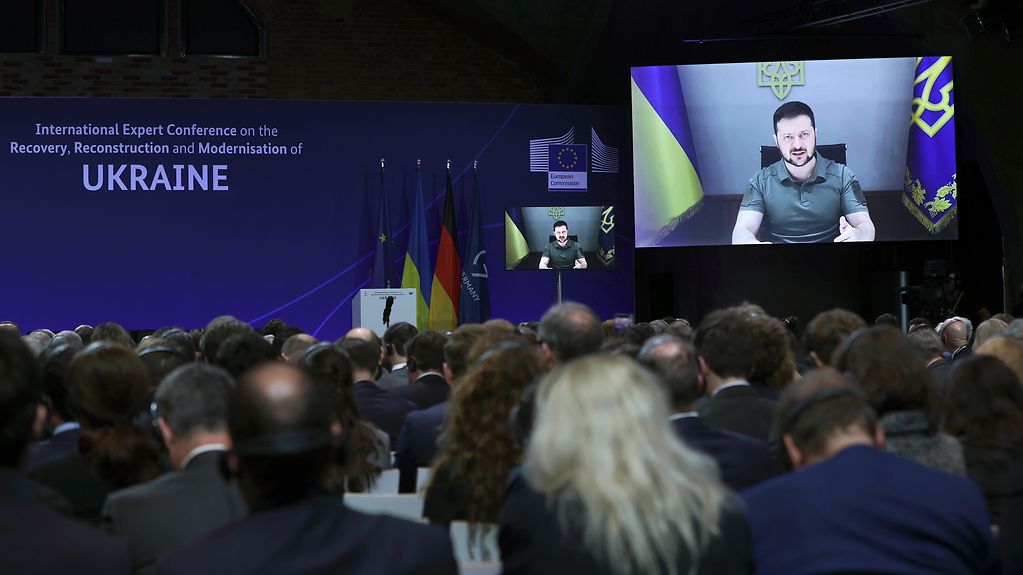 Ukrainian President Volodymyr Zelensky gives a speech at the reconstruction conference via video link