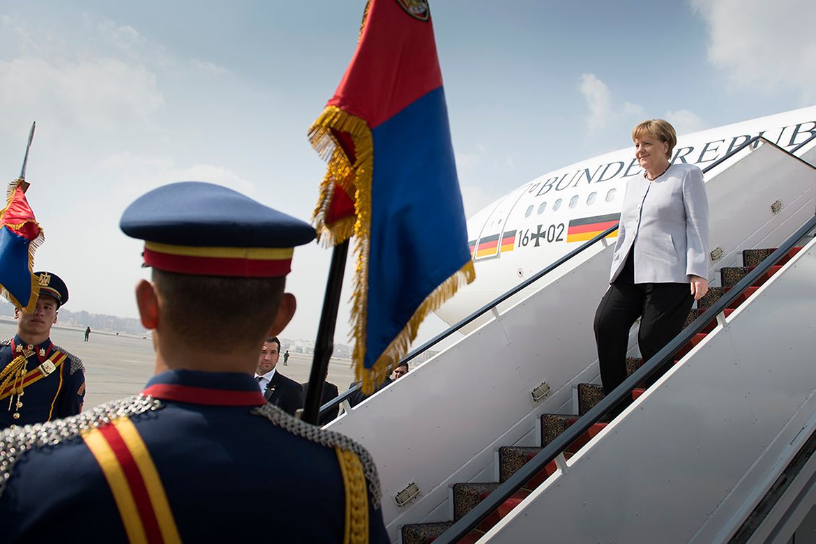 Chancellor Angela Merkel alights from the aircraft at Cairo Airport.