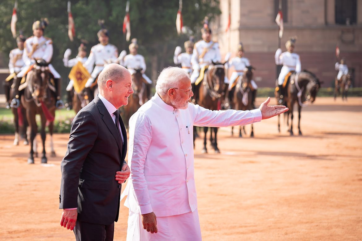 Bundeskanzler Scholz mit dem indischen Premierminister Modi vor einer berittenen militärischen Formation.
