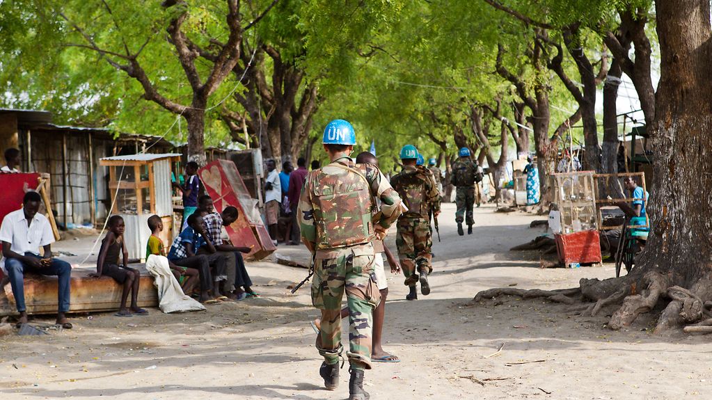 UN-Soldaten mit blauen Helmen führen eine Fußpatrouille in der südsudanesischen Stadt Pibor im Marktbereich durch.