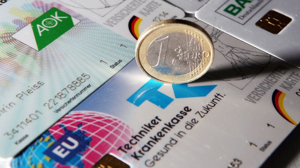 Eine Euromünze steht auf Versichertenkarten gesetzlicher Krankenversicherungen