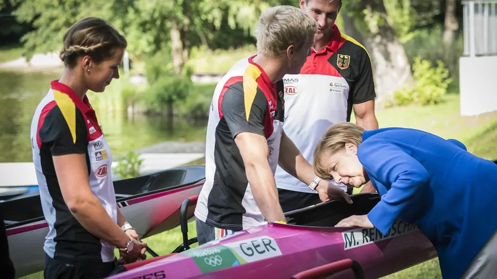 Chancellor Angela Merkel talks to flatwater racing champions.