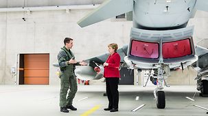Bundeskanzlerin Angela Merkel beim Besuch des Taktischen Luftwaffengeschwaders 31 in Nörvenich im Gespräch mit einem Piloten.