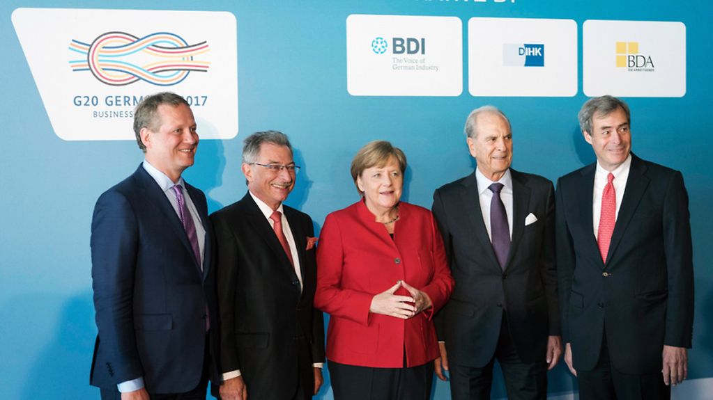 Chancellor Angela Merkel (centre) with leading business representatives during the Business20 (B20) summit in Berlin