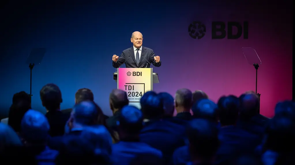 Bundeskanzler am Rednerpult spricht gestikulierend vor Publikum. 