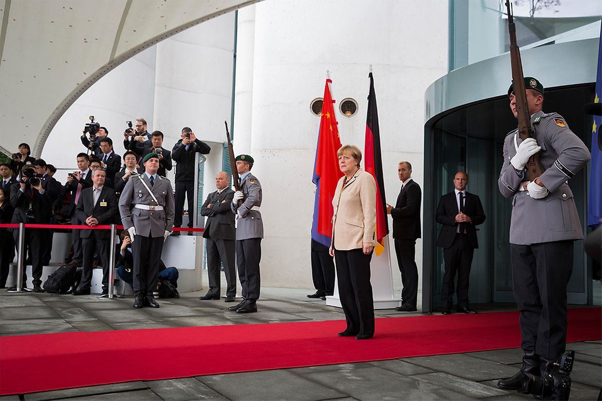 Chancellor Angela Merkel waits in front of the Federal Chancellery.