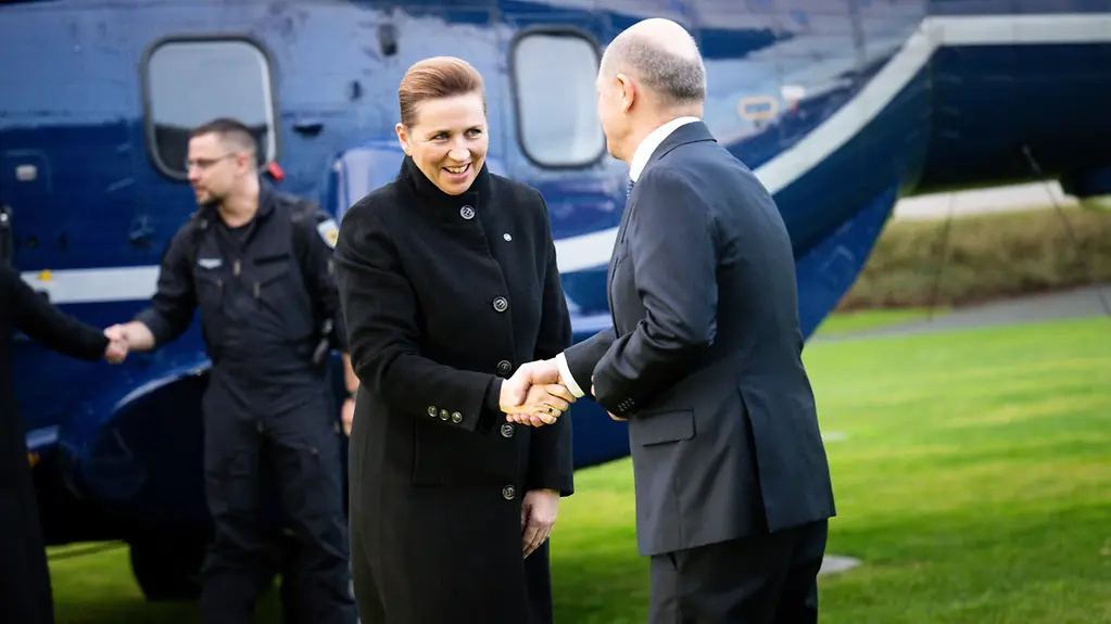 Bundeskanzler Scholz und Mette Frederiksen stehen auf dem Hubschrauberlandeplatz vor dem Bundeskanzleramt.