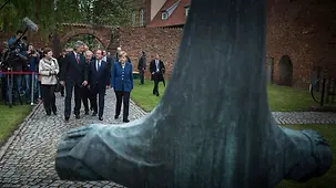 Chancellor Angela Merkel, French President François Hollande and members of their delegations walk to the monastery of St. John