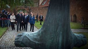 Bundeskanzlerin Angela Merkel und der französische Präsident François Hollande und Delegationsteilnehmer gehen zum Johanniskloster.