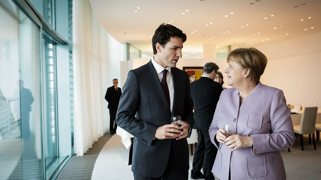 Federal Chancellor Angela Merkel speaks with Canada's Prime Minister Justin Trudeau at the Federal Chancellery