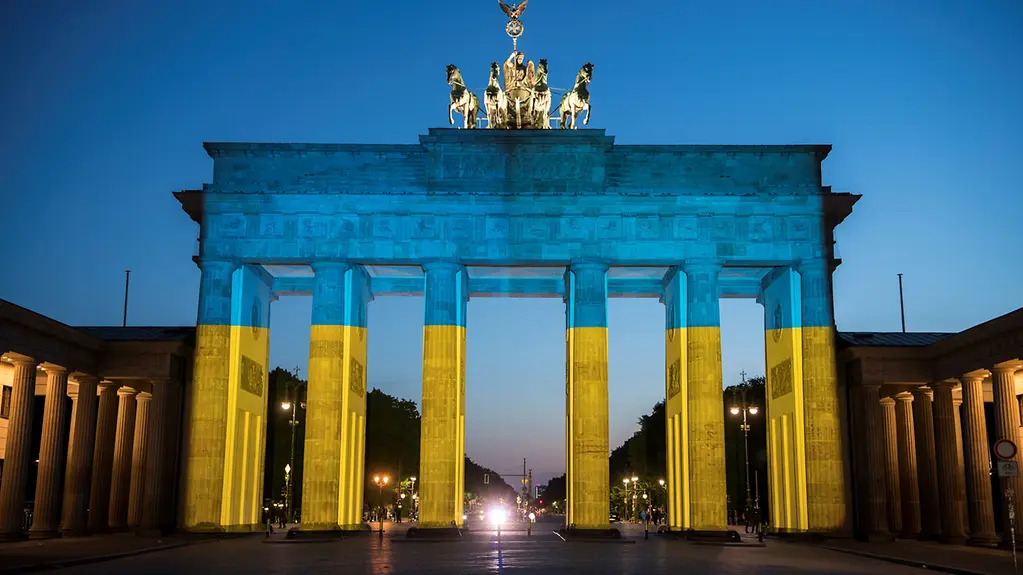 The Brandenburg Gate is illuminated with the colours of the Ukrainian flag