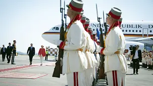 The guard of honour looks towards the two heads of government.