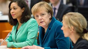 Chancellor Angela Merkel engages in discussion during the working session.
