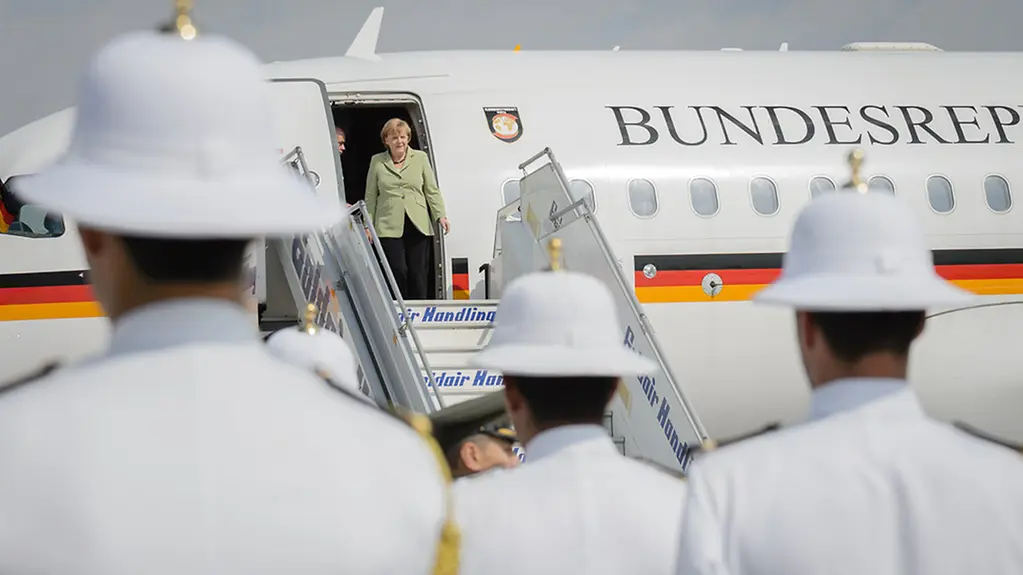 Angela Merkel alights from the government aircraft.