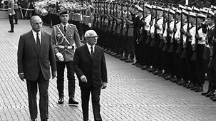 Le chancelier fédéral Helmut Kohl (à g.) reçoit Erich Honecker, le président du Conseil d'État de RDA, avec les honneurs militaires devant la Chancellerie fédérale.